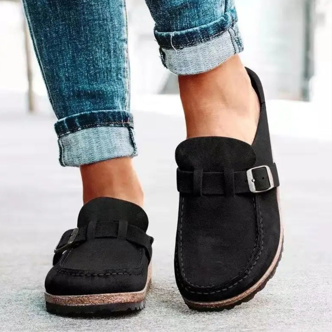 Women's mule sandals with round toes, side buckles and flat layered soles