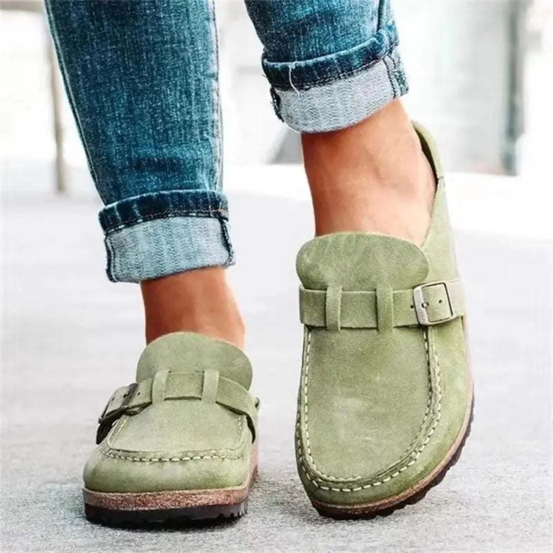 Women's mule sandals with round toes, side buckles and flat layered soles