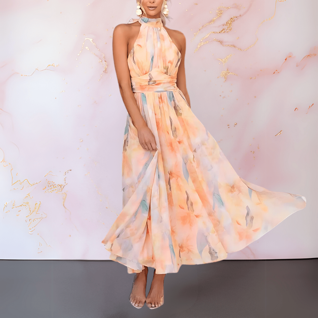 Women's orange abstract watercolour halterneck midi dress with a defined waist and flowing skirt