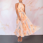 Women's orange abstract watercolour halterneck midi dress with a defined waist and flowing skirt