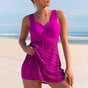 Women's one-piece swimsuit with ruched bodice and patterned skirt overlay