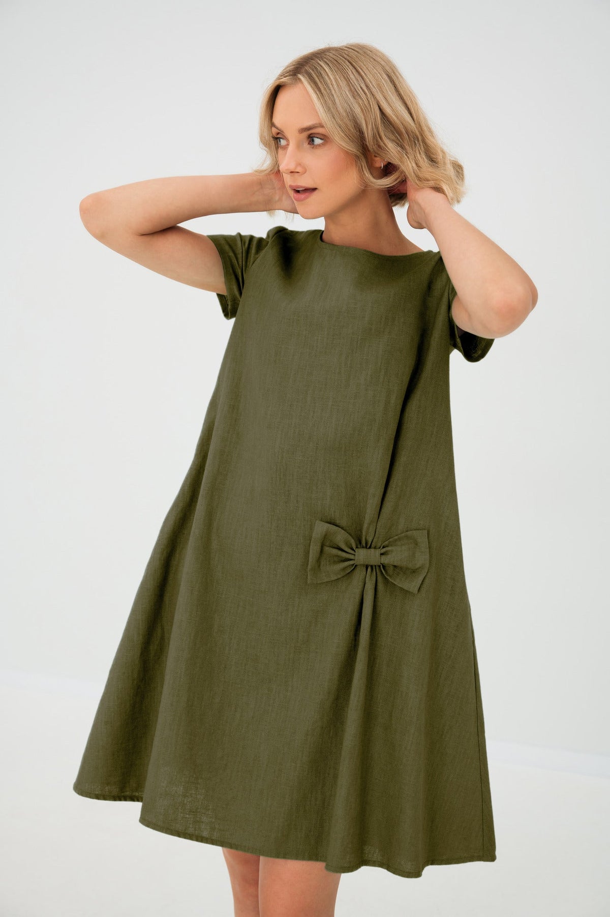Women's A-line short dress with round neckline, short sleeves, bow detail and front pockets