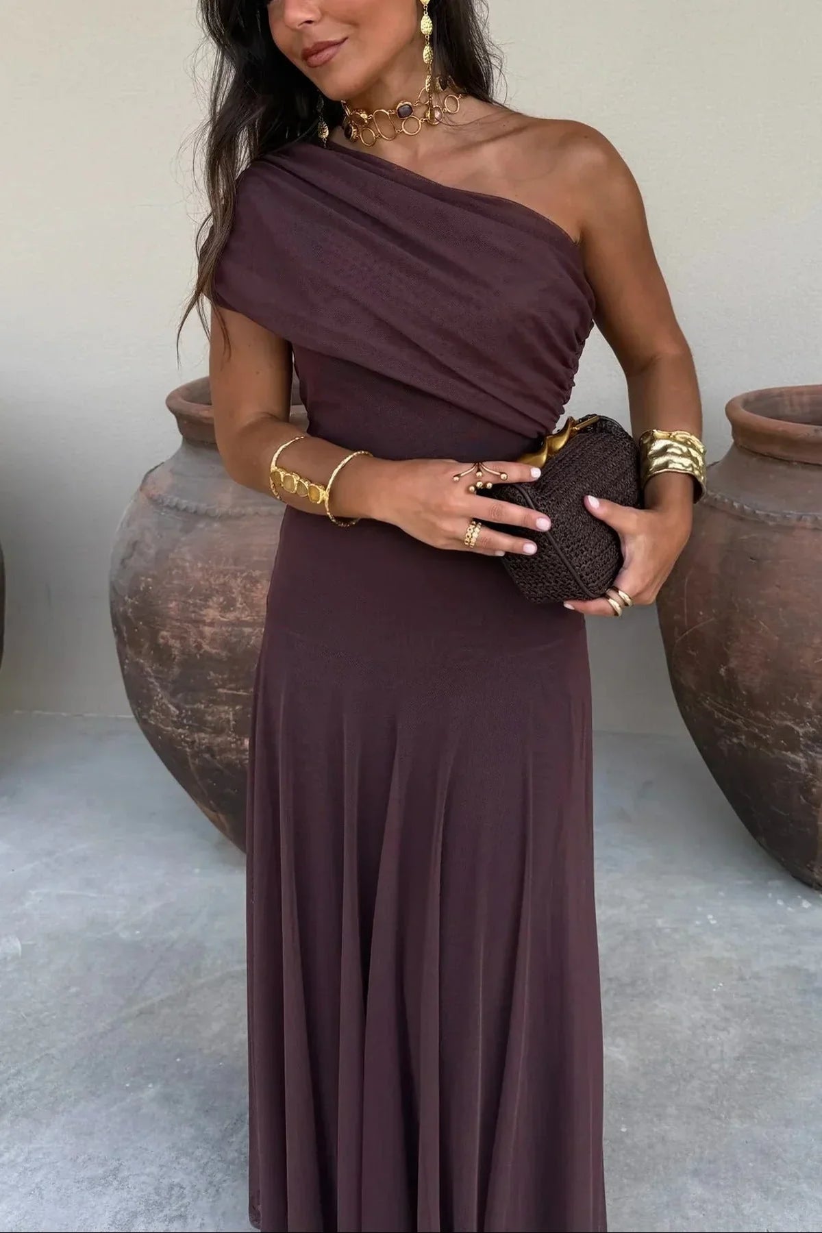 Women's pleated one-shoulder maxi dress with draped bodice and flowing skirt