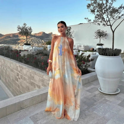 Women's abstract halter maxi dress with flowing sheer overlay and tie back