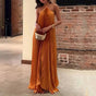 Women's orange pleated halter maxi dress with criss-cross neckline