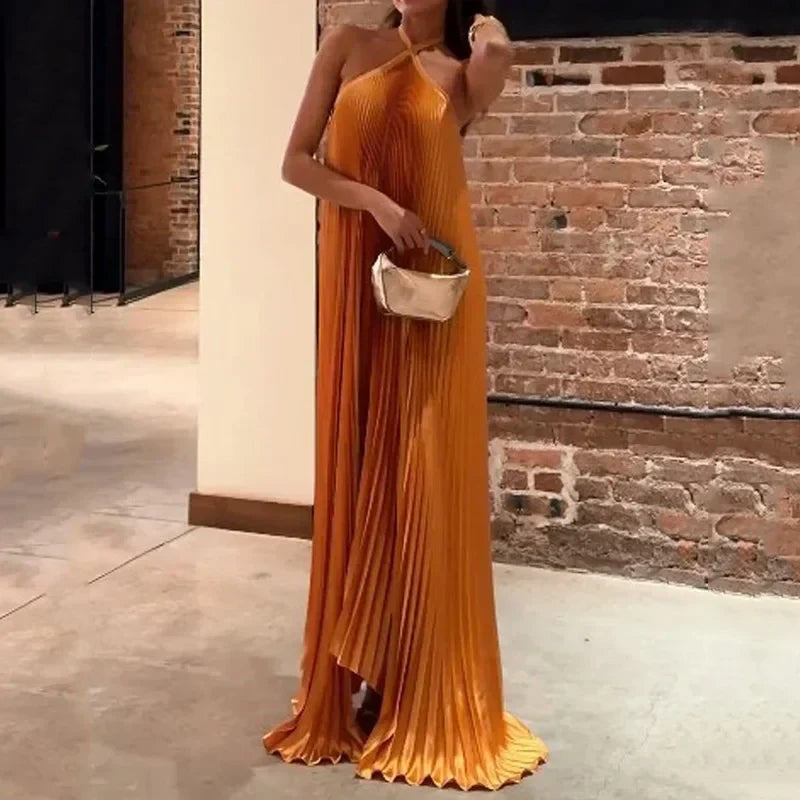 Women's orange pleated halter maxi dress with criss-cross neckline