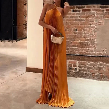 Women's orange pleated halter maxi dress with criss-cross neckline